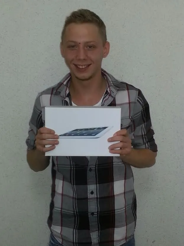 Photo of grinning first tablet raffle winner