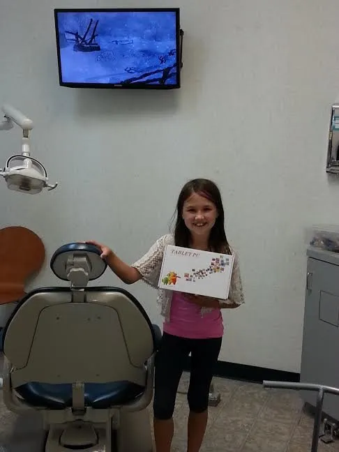 Photo of smiling tablet raffle winner in treatment room