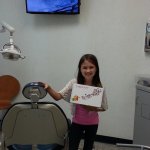 Photo of smiling tablet raffle winner in treatment room